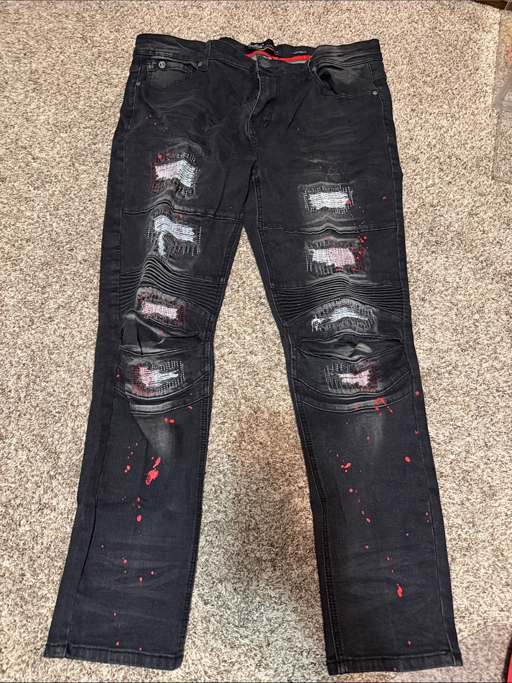 Switch Remarkable Black Distressed Men’s Jeans with Red Paint Splatter
